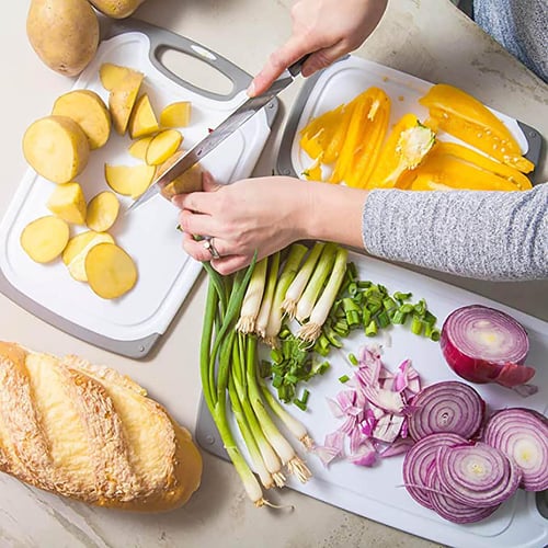 Plastic cutting board with handle outlet